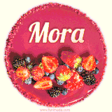 Beautifully decorated red velvet berry birthday cake with vibrant fruits and a glowing 'Mora' name, adding a touch of sweetness and sparkle.