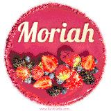 Beautifully decorated red velvet berry birthday cake with vibrant fruits and a glowing 'Moriah' name, adding a touch of sweetness and sparkle.