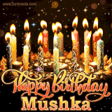 A glowing personalized birthday GIF with name Mushka featuring lit candles with intricate designs, warm lighting, and the text 'Happy Birthday' in an elegant font.