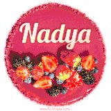 Beautifully decorated red velvet berry birthday cake with vibrant fruits and a glowing 'Nadya' name, adding a touch of sweetness and sparkle.