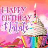 A vibrant birthday GIF featuring a rainbow-colored cupcake topped with white frosting, sprinkles, and a lit candle. The text reads 'Happy Birthday Natale' in bold pink and violet letters with white outline.