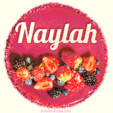 Beautifully decorated red velvet berry birthday cake with vibrant fruits and a glowing 'Naylah' name, adding a touch of sweetness and sparkle.