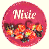 Beautifully decorated red velvet berry birthday cake with vibrant fruits and a glowing 'Nixie' name, adding a touch of sweetness and sparkle.