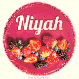 Beautifully decorated red velvet berry birthday cake with vibrant fruits and a glowing 'Niyah' name, adding a touch of sweetness and sparkle.