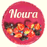 Beautifully decorated red velvet berry birthday cake with vibrant fruits and a glowing 'Noura' name, adding a touch of sweetness and sparkle.