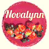 Beautifully decorated red velvet berry birthday cake with vibrant fruits and a glowing 'Novalynn' name, adding a touch of sweetness and sparkle.