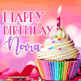 A vibrant birthday GIF featuring a rainbow-colored cupcake topped with white frosting, sprinkles, and a lit candle. The text reads 'Happy Birthday Novia' in bold pink and violet letters with white outline.