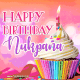 A vibrant birthday GIF featuring a rainbow-colored cupcake topped with white frosting, sprinkles, and a lit candle. The text reads 'Happy Birthday Nukpana' in bold pink and violet letters with white outline.