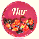 Beautifully decorated red velvet berry birthday cake with vibrant fruits and a glowing 'Nur' name, adding a touch of sweetness and sparkle.