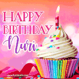 A vibrant birthday GIF featuring a rainbow-colored cupcake topped with white frosting, sprinkles, and a lit candle. The text reads 'Happy Birthday Nuri' in bold pink and violet letters with white outline.