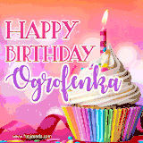 A vibrant birthday GIF featuring a rainbow-colored cupcake topped with white frosting, sprinkles, and a lit candle. The text reads 'Happy Birthday Ogrofenka' in bold pink and violet letters with white outline.