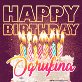 A colorful birthday cake topped with lit candles, with the words 'Happy Birthday Ogrufina' in bold glowing letters on a burgundy background. Animated flames add a festive touch.