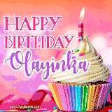 A vibrant birthday GIF featuring a rainbow-colored cupcake topped with white frosting, sprinkles, and a lit candle. The text reads 'Happy Birthday Olayinka' in bold pink and violet letters with white outline.