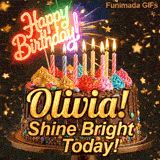 Yellow script spelling the name Olivia! on a classic chocolate cake under a glowing pink neon Happy Birthday sign.