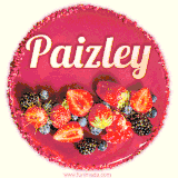 Beautifully decorated red velvet berry birthday cake with vibrant fruits and a glowing 'Paizley' name, adding a touch of sweetness and sparkle.