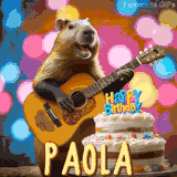 Animated birthday GIF showing a capybara playing guitar and singing beside a birthday cake with the name Paola in large letters and colorful bokeh lights in the background.