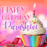 A vibrant birthday GIF featuring a rainbow-colored cupcake topped with white frosting, sprinkles, and a lit candle. The text reads 'Happy Birthday Paraskeve' in bold pink and violet letters with white outline.