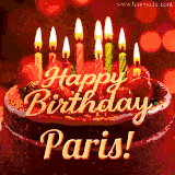 Beautifully decorated red velvet berry birthday cake with vibrant fruits and a glowing 'Paris' name, adding a touch of sweetness and sparkle.