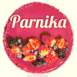 Beautifully decorated red velvet berry birthday cake with vibrant fruits and a glowing 'Parnika' name, adding a touch of sweetness and sparkle.
