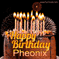 A rich chocolate cake topped with glowing birthday candles and surrounded by bright fireworks. The animated GIF displays the message 'Happy Birthday Pheonix' in golden text.