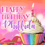 A vibrant birthday GIF featuring a rainbow-colored cupcake topped with white frosting, sprinkles, and a lit candle. The text reads 'Happy Birthday Phillida' in bold pink and violet letters with white outline.