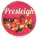 Beautifully decorated red velvet berry birthday cake with vibrant fruits and a glowing 'Presleigh' name, adding a touch of sweetness and sparkle.