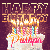 A colorful birthday cake topped with lit candles, with the words 'Happy Birthday Pushpa' in bold glowing letters on a burgundy background. Animated flames add a festive touch.