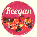 Beautifully decorated red velvet berry birthday cake with vibrant fruits and a glowing 'Reegan' name, adding a touch of sweetness and sparkle.