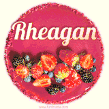 Beautifully decorated red velvet berry birthday cake with vibrant fruits and a glowing 'Rheagan' name, adding a touch of sweetness and sparkle.