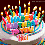 A colorful birthday cake topped with lit candles, with the words 'Happy Birthday Ria' in bold glowing letters on a burgundy background. Animated flames add a festive touch.