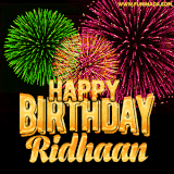 A captivating GIF with bursts of green, pink, and orange fireworks lighting up the night sky, accompanied by 'Happy Birthday Ridhaan' in glowing golden text.