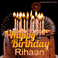 A rich chocolate cake topped with glowing birthday candles and surrounded by bright fireworks. The animated GIF displays the message 'Happy Birthday Rihaan' in golden text.
