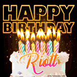 A vibrant animated GIF featuring a delicious birthday cake topped with glowing candles and the name 'Riott' in elegant script, and the words 'Happy Birthday' on the black background.