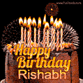 A rich chocolate cake topped with glowing birthday candles and surrounded by bright fireworks. The animated GIF displays the message 'Happy Birthday Rishabh' in golden text.