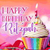 A vibrant birthday GIF featuring a rainbow-colored cupcake topped with white frosting, sprinkles, and a lit candle. The text reads 'Happy Birthday Ritzpah' in bold pink and violet letters with white outline.