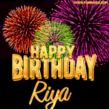A golden 'Happy Birthday Riya' message with vibrant fireworks in the background, creating a festive and celebratory vibe in this animated name GIF.