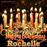 A glowing personalized birthday GIF with name Rochelle featuring lit candles with intricate designs, warm lighting, and the text 'Happy Birthday' in an elegant font.