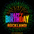 A colorful animated GIF featuring the text 'Happy Birthday Rockland!' in rainbow colors with a dynamic iridescent firework display in the background.