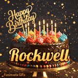 Flickering candles of different colors on top of a chocolate glaze cake with Rockwell's name in elegant writing.