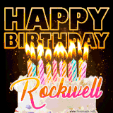 A vibrant animated GIF featuring a delicious birthday cake topped with glowing candles and the name 'Rockwell' in elegant script, and the words 'Happy Birthday' on the black background.