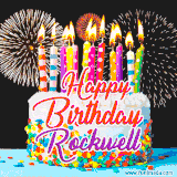 A lively happy birthday animated GIF showcasing a colorful birthday cake covered in sprinkles, topped with glowing candles, and surrounded by vibrant fireworks. The name 'Rockwell' is featured in elegant script.