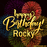 A vibrant display of multicolor fireworks with the text 'Happy Birthday Rocky' written in gold, glowing beautifully in front of the explosive background.