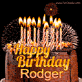 A rich chocolate cake topped with glowing birthday candles and surrounded by bright fireworks. The animated GIF displays the message 'Happy Birthday Rodger' in golden text.