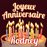 A Happy Birthday GIF in French featuring a festive birthday cake adorned with bright candles and the glowing text 'Joyeux Anniversaire Rodney' in a cheerful style.
