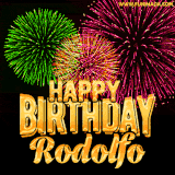 A captivating GIF with bursts of green, pink, and orange fireworks lighting up the night sky, accompanied by 'Happy Birthday Rodolfo' in glowing golden text.