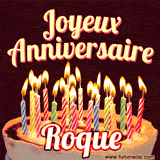 A Happy Birthday GIF in French featuring a festive birthday cake adorned with bright candles and the glowing text 'Joyeux Anniversaire Roque' in a cheerful style.