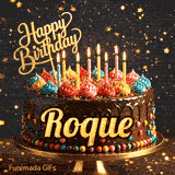 Rich chocolate cake decorated with sprinkles, colorful icing, lit candles, and the name Roque in bold golden script.