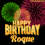 A captivating GIF with bursts of green, pink, and orange fireworks lighting up the night sky, accompanied by 'Happy Birthday Roque' in glowing golden text.