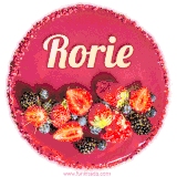 Beautifully decorated red velvet berry birthday cake with vibrant fruits and a glowing 'Rorie' name, adding a touch of sweetness and sparkle.