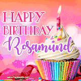 A vibrant birthday GIF featuring a rainbow-colored cupcake topped with white frosting, sprinkles, and a lit candle. The text reads 'Happy Birthday Rosamund' in bold pink and violet letters with white outline.